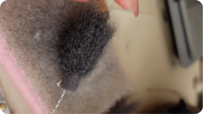 Needle-felted portrait making process step 6