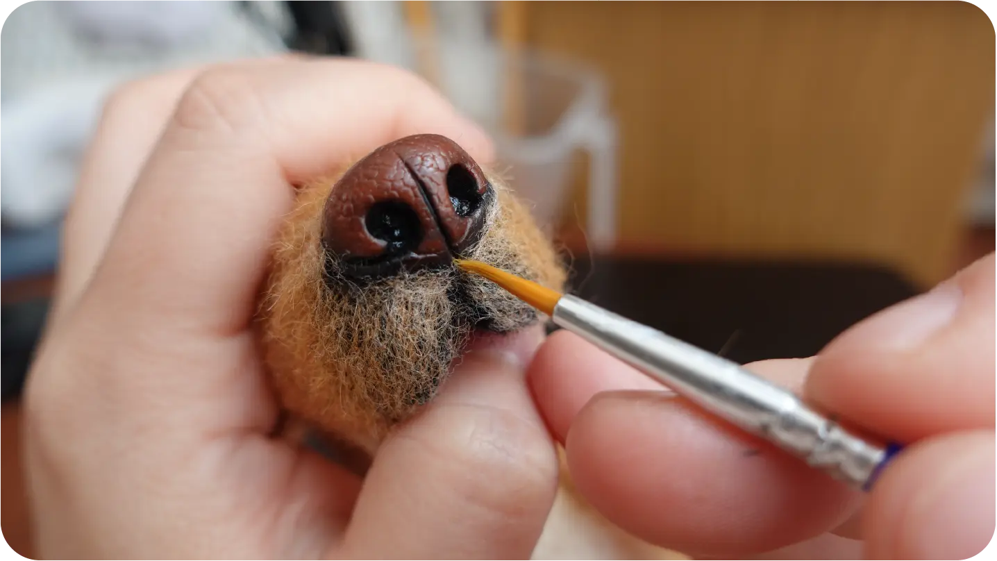 Needle-felted portrait making process step 5