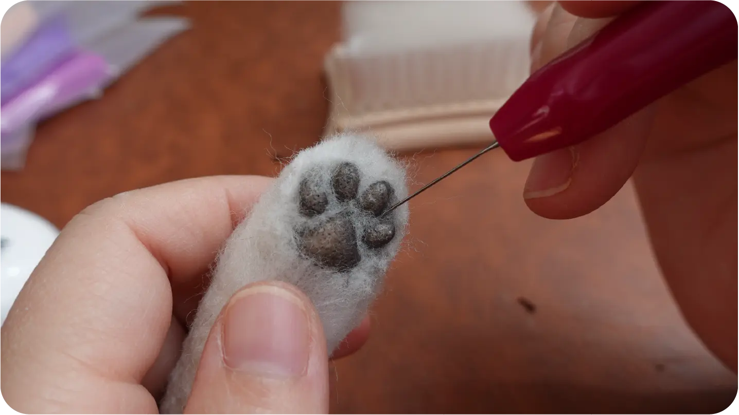 Needle-felted portrait making process step 7