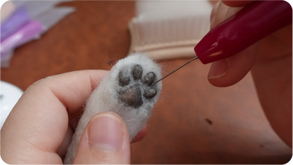Needle-felted portrait making process step 7
